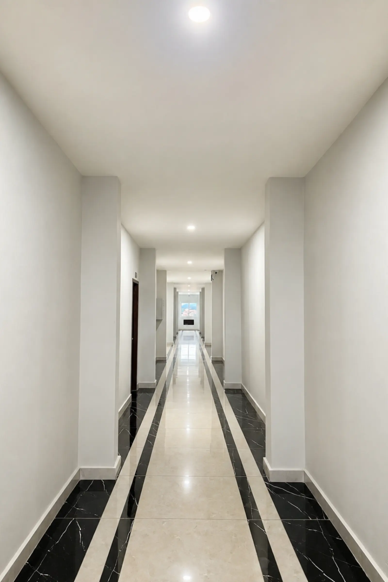 Guest-room corridor with daylight at the far end