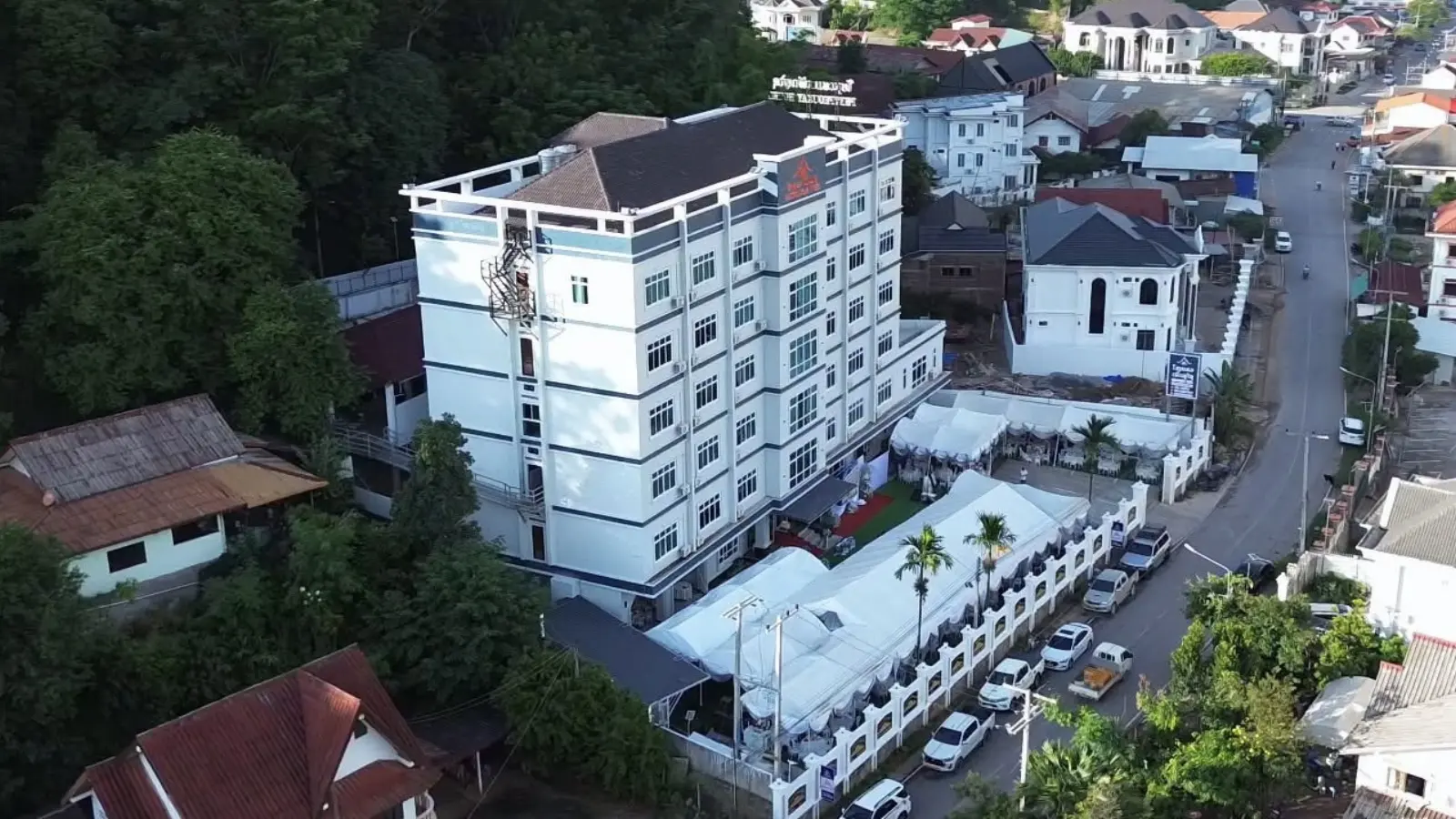 The hotel from the air, on its street above the town