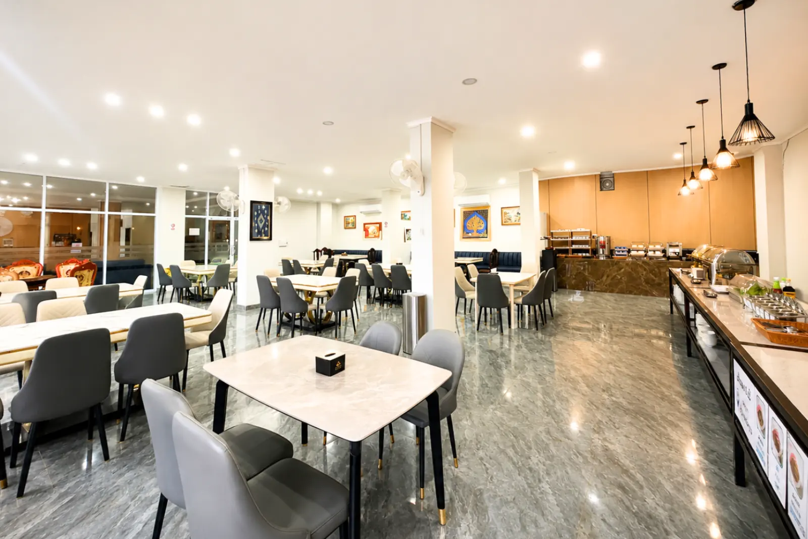 Restaurant dining hall with marble-top tables and the breakfast counter