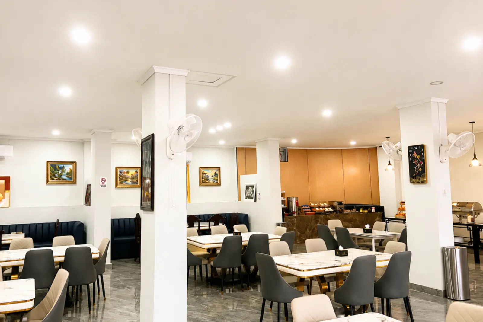 Dining room seating between the pillars, with the buffet at the back