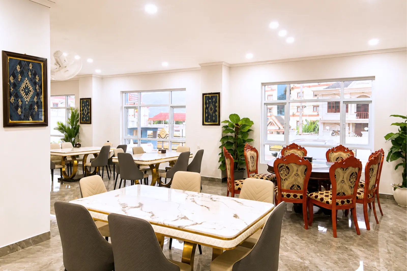 Restaurant tables beside the windows, with the town outside