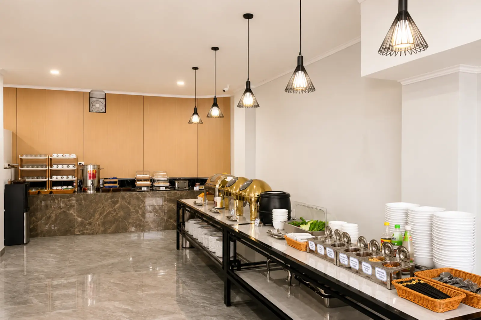 Breakfast counter running the length of the dining room, set with plates and condiments