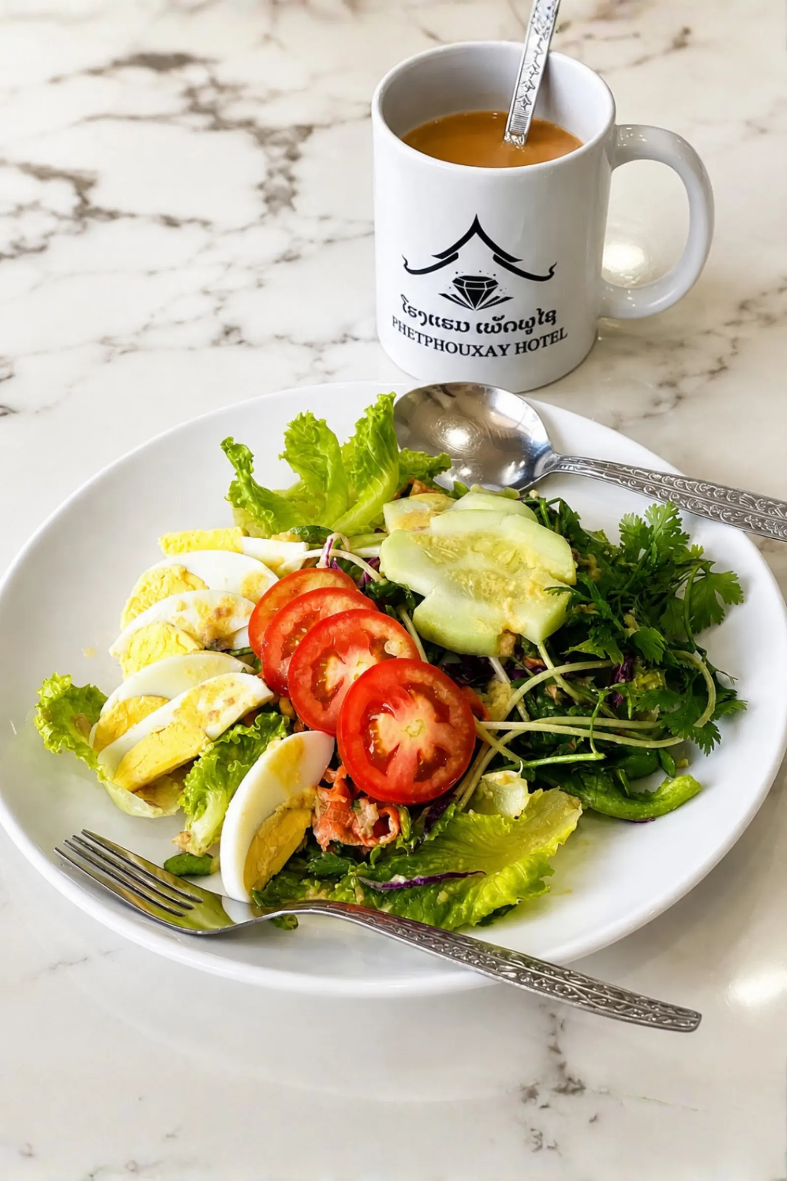 Salad plate with tomato, cucumber, egg and fresh herbs