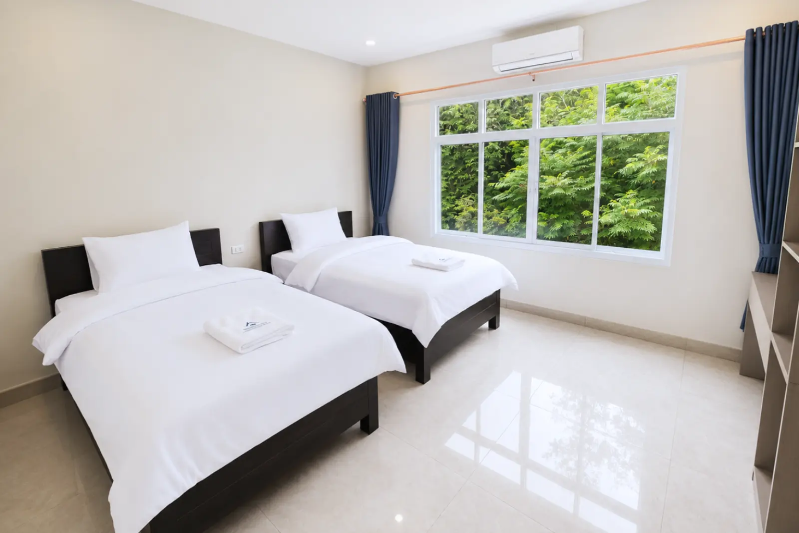 Twin room looking onto green treetops