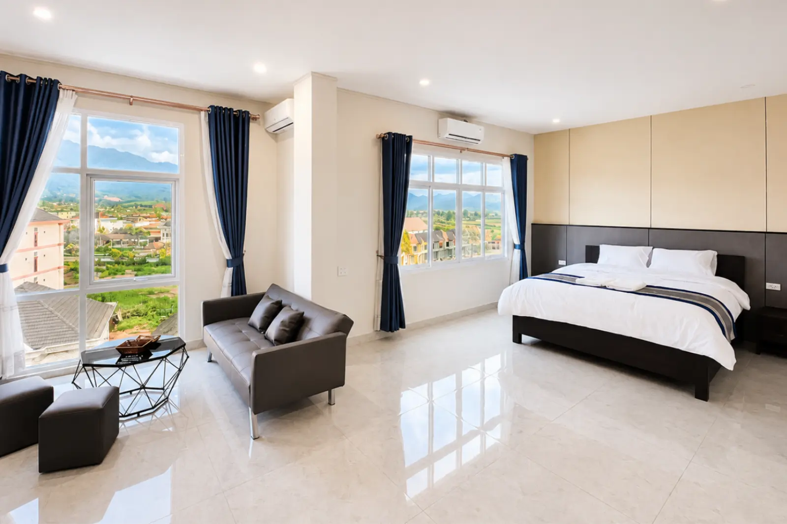 VIP room with king bed, sofa and two windows over the valley