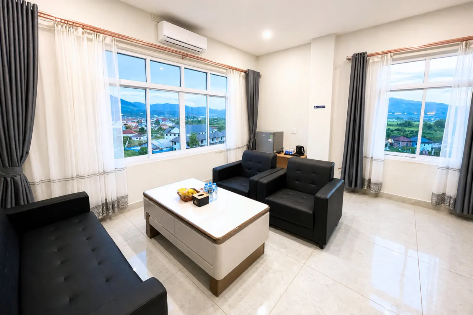 VVIP suite living room with windows on two walls over the valley