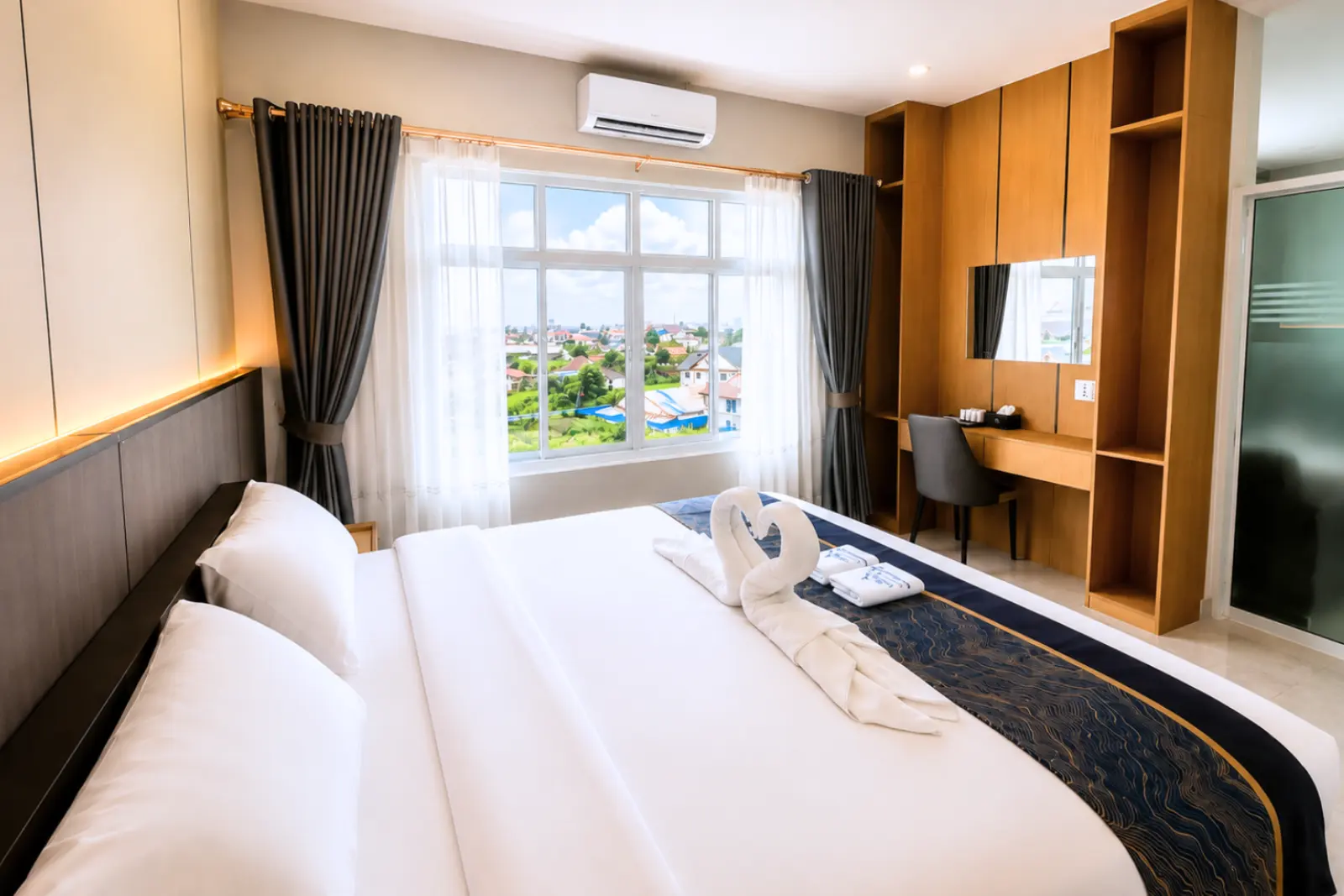 VVIP suite king bed with turndown detail, window and dressing area